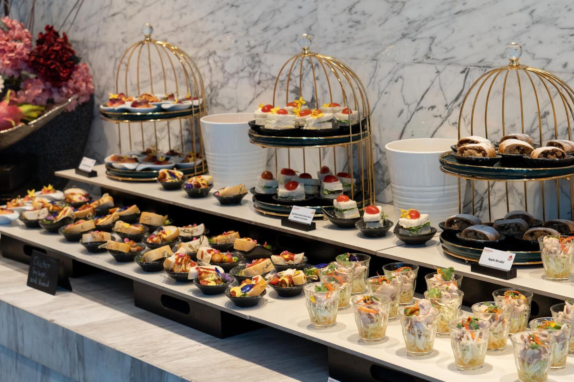 Moevenpick Hotel Sukhumvit 15 Bangkok Exterior photo A buffet of hors d'oeuvres